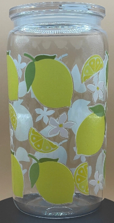 Clear plastic tumbler with lemon pattern on a beige background
