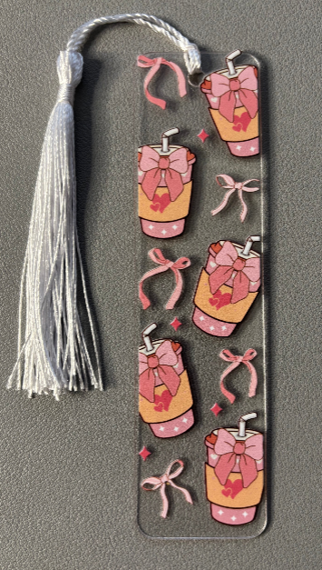 Decorative bookmark with pink coffee cups and ribbons on a gray background