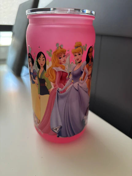 Pink tumbler with Disney princesses on a white surface