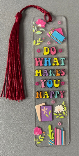 Decorative bookmark with colorful text and tassel on a gray background