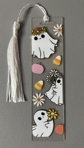 Decorative bookmark with ghost illustrations, flowers, and a tassel on a gray background