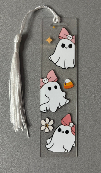 Bookmark with cartoon ghosts wearing pink bows on a gray background
