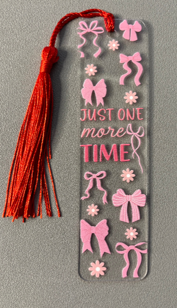 Decorative bookmark with pink bows, flowers, and text saying just one more time on a gray background