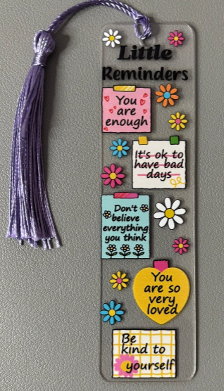 Decorative bookmark with motivational phrases and colorful designs on a gray background