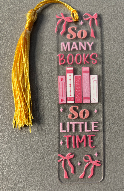 Decorative bookmark with books and text saying so many books so little time on a gray background